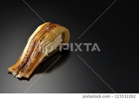 Grilled conger eel sushi photographed against a black background Grilled conger eel sushi photographed against a black background 123532262
