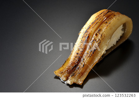 Grilled conger eel sushi photographed against a black background 123532263