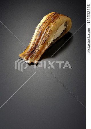 Grilled conger eel sushi photographed against a black background 123532268