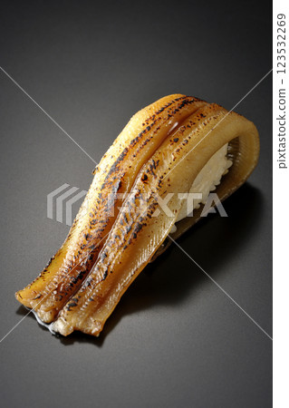 Grilled conger eel sushi photographed against a black background 123532269