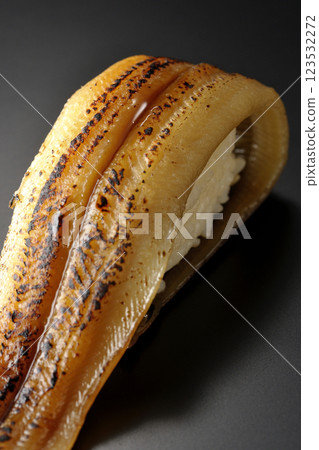 Grilled conger eel sushi photographed against a black background Grilled conger eel sushi photographed against a black background 123532272