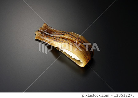 Grilled conger eel sushi photographed against a black background Grilled conger eel sushi photographed against a black background 123532273