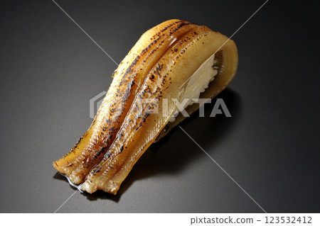 Grilled conger eel sushi photographed against a black background Grilled conger eel sushi photographed against a black background 123532412