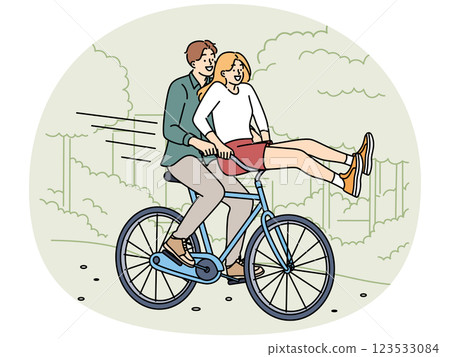 Overjoyed couple ride bike in park 123533084
