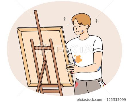 Young man drawing picture on easel Young man drawing picture on easel 123533099