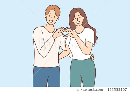 Man and woman in love make heart gesture together, demonstrating sympathy and affection for partner 123533107
