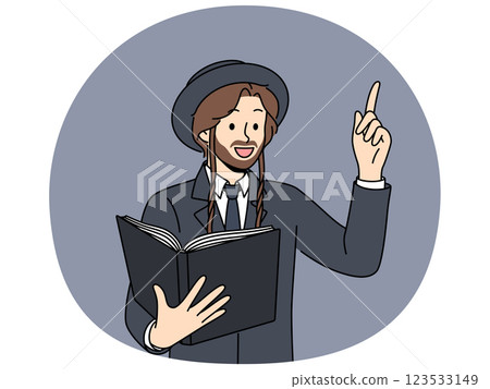 Jewish man holds book with religious texts and points finger up talking about israelite religion 123533149