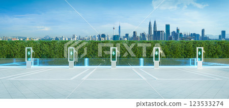 Electric vehicle charging station with kuala lumpur skyline: promoting sustainable transportation 123533274
