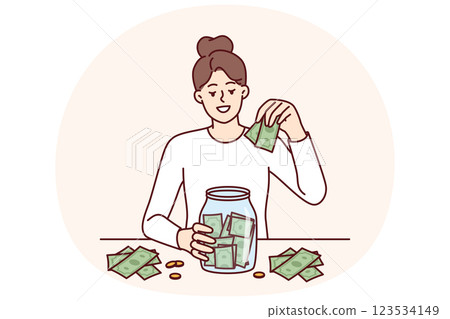 Woman puts money in jar wanting to save up to buy own house or start successful business 123534149