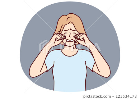 Crying woman wipes tears with hands because of breakup with boyfriend or depression 123534178