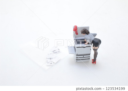 Office Scene with Woman Using Copier in Creative Pose Office Scene with Woman Using Copier in Creative Pose 123534199