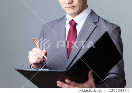 Middle-aged male businessman looking at documents 123534224