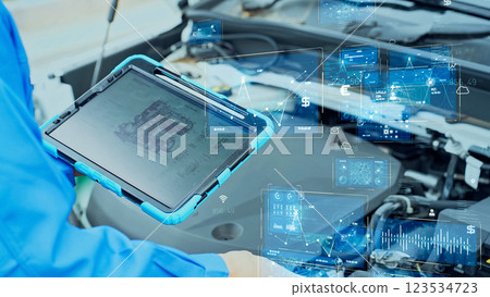 Auto mechanic inspecting the engine room of a car and digital data image Auto mechanic inspecting the engine room of a car and digital data image 123534723