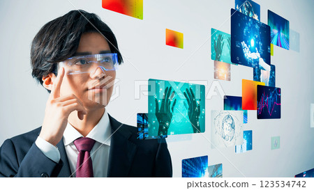 A man looking at a holographic image with VR goggles 123534742