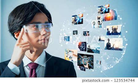 A man looking at a holographic image with VR goggles 123534744