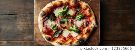 Rustic pizza with basil and olive oil served on a wooden board ready for enjoyment 123535666