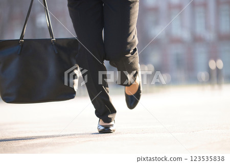The feet of a young woman running through an office district The feet of a young woman running through an office district 123535838