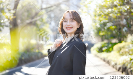 Young business woman walking in a suit 123536092