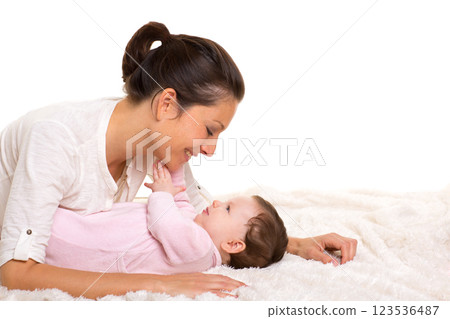 Baby girl and mother lying happy playing together Baby girl and mother lying happy playing together 123536487