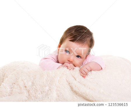 baby girl with toothache in pink with on white fur 123536615