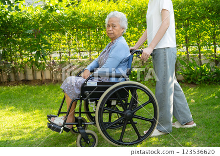 caregiver help and care Asian senior woman patient sitting on wheelchair at nursing hospital ward, healthy strong medical. 123536620