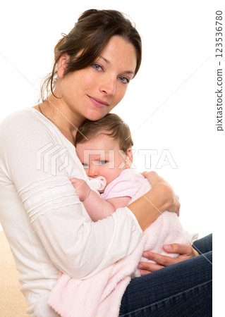 Baby girl relaxed with pacifier hug in mother arms 123536780