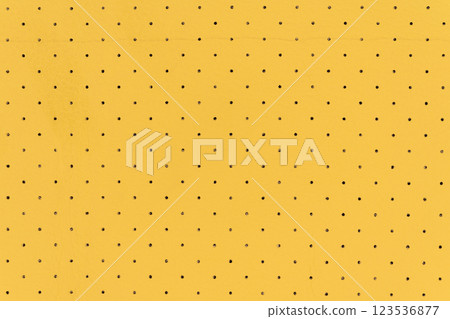 Yellow color abstract artificial leather with small dots and holes pattern for background 123536877