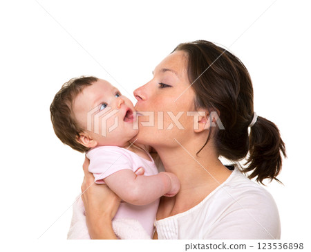 Beautiful mother kissing baby girl hug on white Beautiful mother kissing baby girl hug on white 123536898
