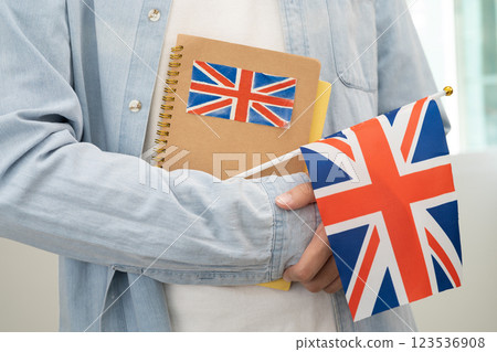 Learn English language, Asian teenage student hold book with flag in course at school. Learn English language, Asian teenage student hold book with flag in course at school. 123536908
