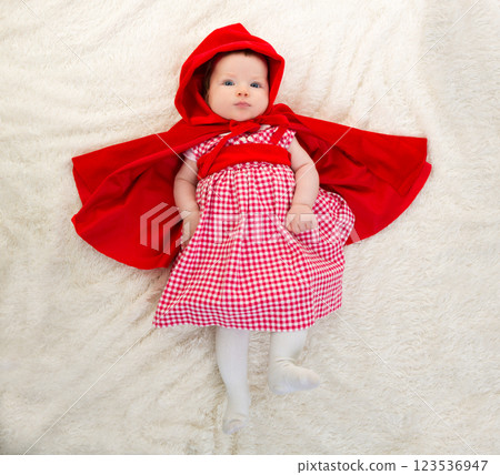 Baby Little Red Riding Hood on white fur 123536947