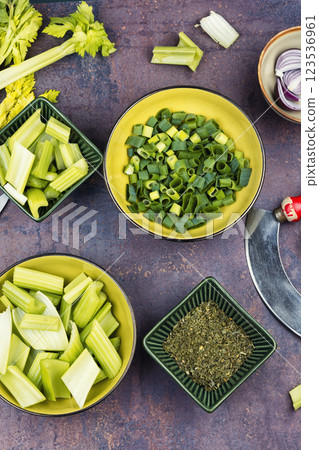 Cut celery sticks and leaves on table. 123536961