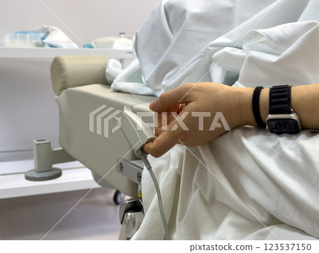 Patient with Pulse Oximeter in Hospital Setting 123537150