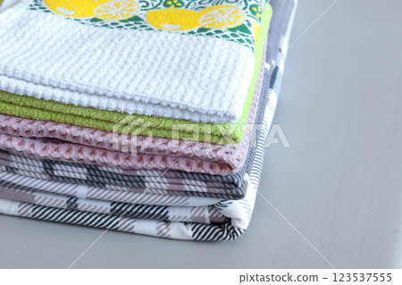 Clean after washing waffle kitchen towels, flannel plaid linens. Stacked pillowcases, duvet cover after ironing. Cleanliness and housekeeping. Clean after washing waffle kitchen towels, flannel plaid linens. Stacked pillowcases, duvet cover after ironing. Cleanliness and housekeeping. 123537555