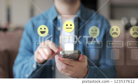 Close-up of man hands using smartphone, rating of the quality of service,store, service and social networks. Satisfaction survey concept reviews customer quality assessment. 123537612