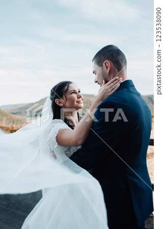 Portrait of beautiful wedding couple hugging, standing outside near ruins. Portrait of beautiful wedding couple hugging, standing outside near ruins. 123538090