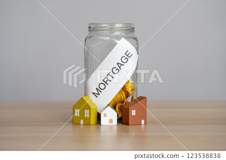 Bank of coins Mortgage. The accumulation of money to pay interest rates on mortgages. Buying a property in debt. Take credit for housing. Mortgage tax and loan concept. Bank of coins Mortgage. The accumulation of money to pay interest rates on mortgages. Buying a property in debt. Take credit for housing. Mortgage tax and loan concept. 123538838