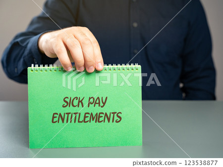 Sick pay entitlements concept. Right of employees to receive compensation from their employer or a government program while they are unable to work due to illness or injury. Notepad in the hands Sick pay entitlements concept. Right of employees to receive compensation from their employer or a government program while they are unable to work due to illness or injury. Notepad in the hands 123538877