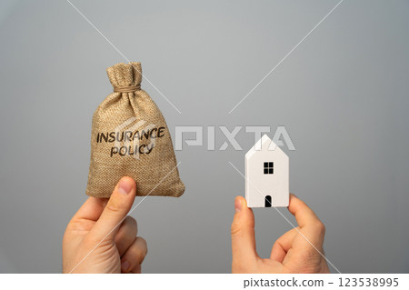 Money bag with Insurance policy and house. In real estate refers to various types of coverage that protect property owners, investors, and businesses from financial loss related to real estate assets Money bag with Insurance policy and house. In real estate refers to various types of coverage that protect property owners, investors, and businesses from financial loss related to real estate assets 123538995