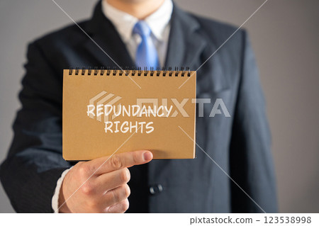Redundancy rights concept. Legal protections and entitlements employees have when they are made redundant due to their job no longer being necessary. Businessman in suit holding notebook Redundancy rights concept. Legal protections and entitlements employees have when they are made redundant due to their job no longer being necessary. Businessman in suit holding notebook 123538998