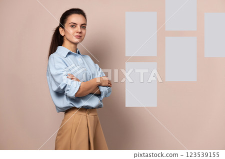 Confident pretty businesswoman near sticky papers on wall, female leader, mock up, Project and schedule concept 123539155