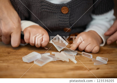 close-up, mother helps her little child girl using knife for preparing hand-made soap, art workshops for children. close-up, mother helps her little child girl using knife for preparing hand-made soap, art workshops for children. 123539205