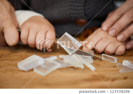 close-up, mother helps her little child girl using knife for preparing hand-made soap, art workshops for children. 123539206