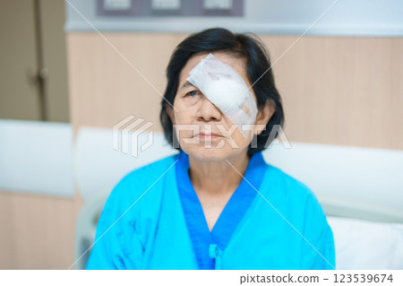 Elderly Woman with eye protective shield after eye surgery. Eye disease, Cataract, Glaucoma, Age Related Macular Degeneration, Diabetic Retinopathy, Vitreous, Lasik, World Glaucoma day and health Elderly Woman with eye protective shield after eye surgery. Eye disease, Cataract, Glaucoma, Age Related Macular Degeneration, Diabetic Retinopathy, Vitreous, Lasik, World Glaucoma day and health 123539674