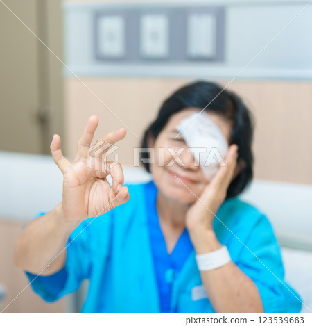 Elderly Woman with eye protective shield after eye surgery. Eye disease, Cataract, Glaucoma, Age Related Macular Degeneration, Diabetic Retinopathy, Vitreous, Lasik, World Glaucoma day and health Elderly Woman with eye protective shield after eye surgery. Eye disease, Cataract, Glaucoma, Age Related Macular Degeneration, Diabetic Retinopathy, Vitreous, Lasik, World Glaucoma day and health 123539683