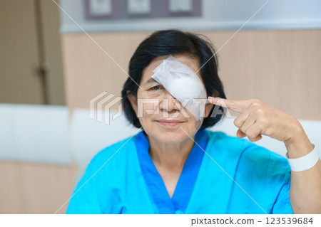 Elderly Woman with eye protective shield after eye surgery. Eye disease, Cataract, Glaucoma, Age Related Macular Degeneration, Diabetic Retinopathy, Vitreous, Lasik, World Glaucoma day and health Elderly Woman with eye protective shield after eye surgery. Eye disease, Cataract, Glaucoma, Age Related Macular Degeneration, Diabetic Retinopathy, Vitreous, Lasik, World Glaucoma day and health 123539684