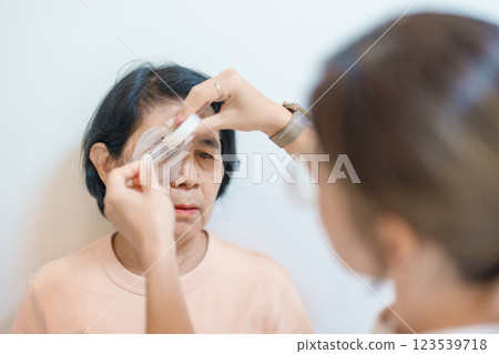 Senior Woman during eye protecting by shield after eye surgery. Eye disease, Cataract,  Glaucoma, Age Related Macular Degeneration, Diabetic Retinopathy, Vitreous, Lasik, World Glaucoma day and health 123539718