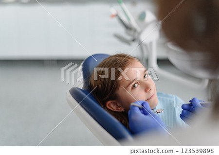 Cute girl during annual dental check-up in dental clinic. Cute girl during annual dental check-up in dental clinic. 123539898