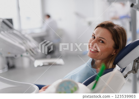 A woman in dentist chair during her annual ceck up in dental clinic. A woman in dentist chair during her annual ceck up in dental clinic. 123539903