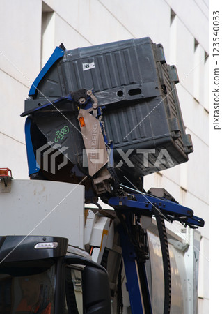 A special machine empties garbage cans 123540033