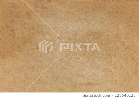 The background texture is a rough brown glossy surface with streaks and spots in close-up The background texture is a rough brown glossy surface with streaks and spots in close-up 123540123